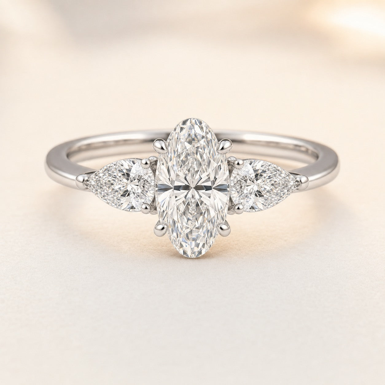 Moval Three Stone Engagement Ring With Pear Side Stones