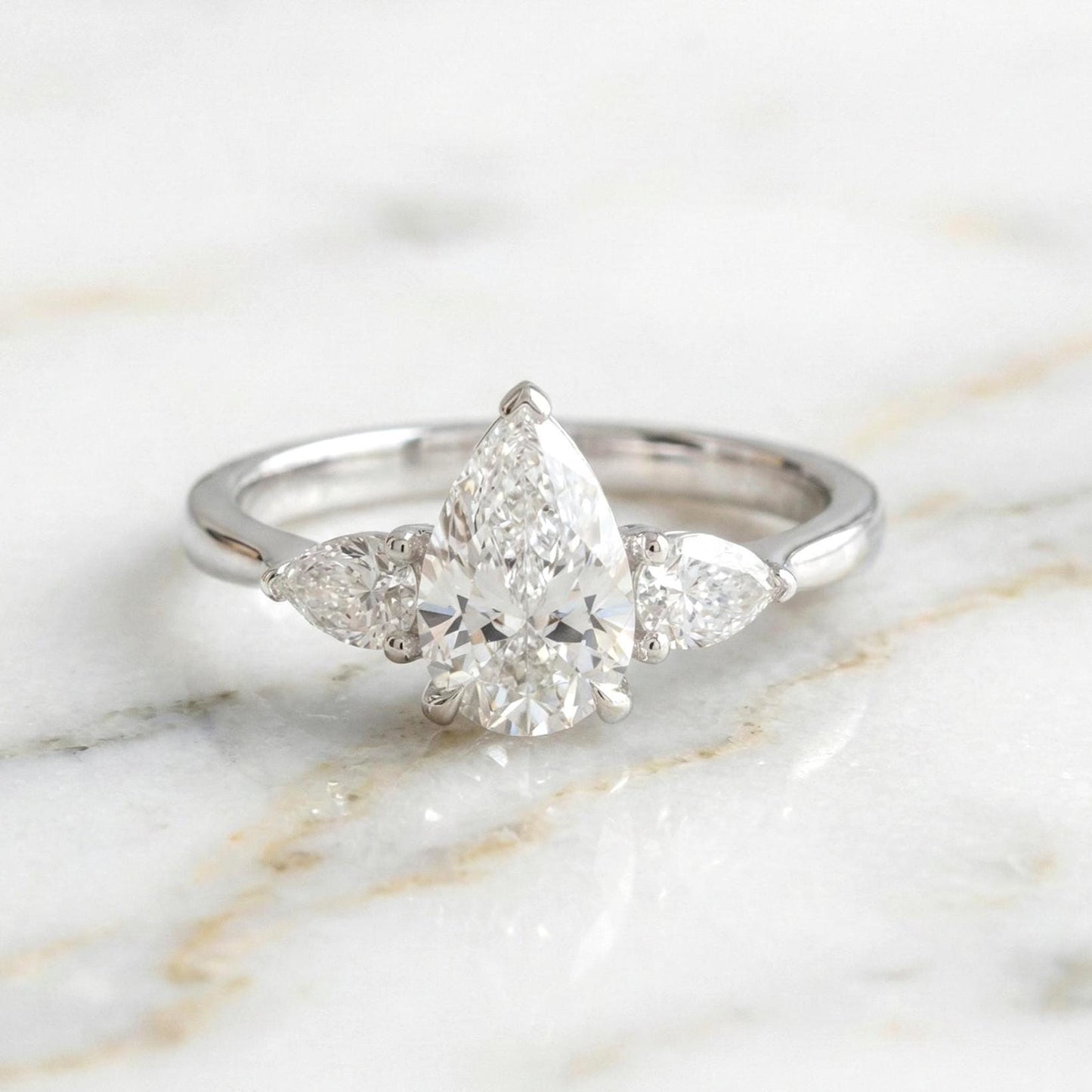 Bague de Fiançailles Trilogie Poire 2,5 Carats en Diamant de Laboratoire Certifié IGI Pear cut Moissanite engagement ring in Gold or Platinum — custom handcrafted by Forever For Love