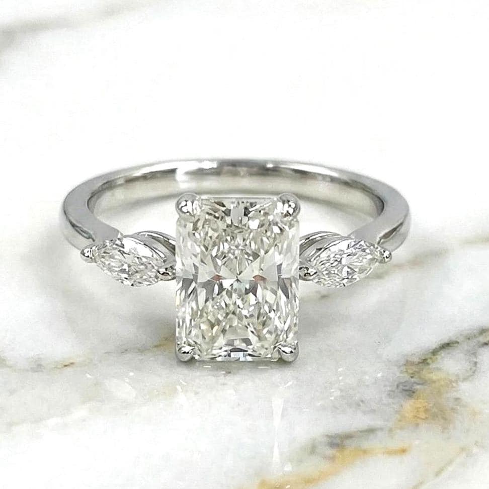 2.25 carat E/VVS2 IGI CERTIFIED Elongated Radiant Cut Lab Grown Diamond Three Stone Engagement Ring. Side Marquise Diamonds, 14k White Gold Radiant cut Moissanite engagement ring in Gold or Platinum — custom handcrafted by Forever For Love