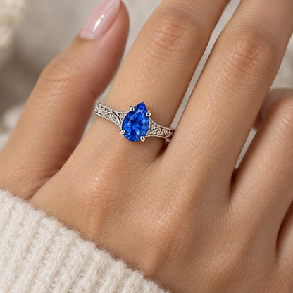 Blue sapphire ring worn on a hand