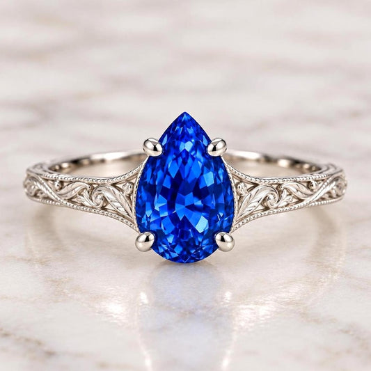 Pear-shaped blue sapphire ring with engraved shoulders
