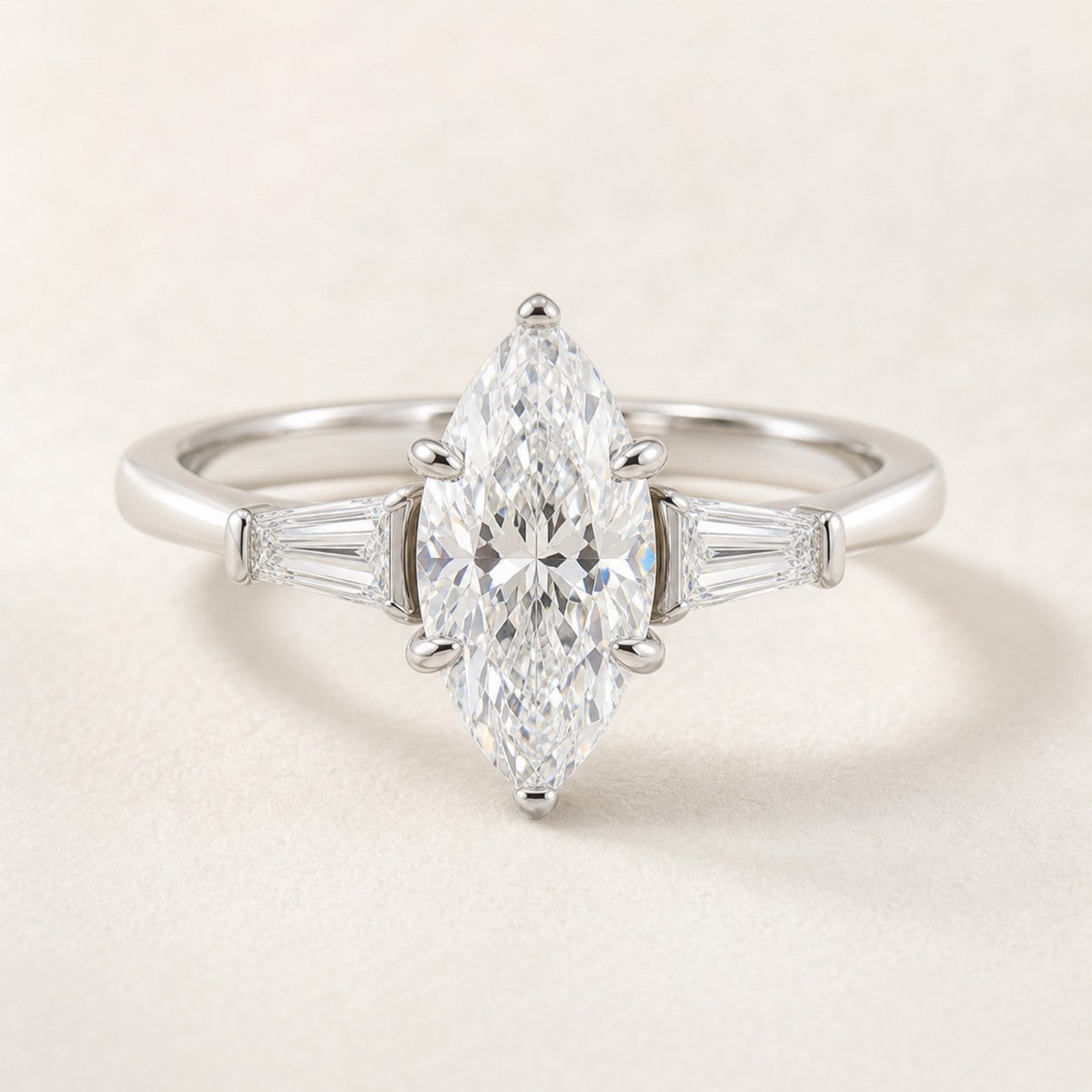 Moval Three Stone Engagement Ring With Tapered Baguette Accents